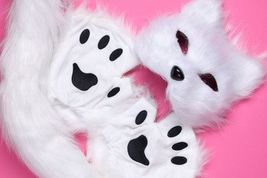 Photo of Quadrobics. Cat mask, tail and gloves on pink background, top view