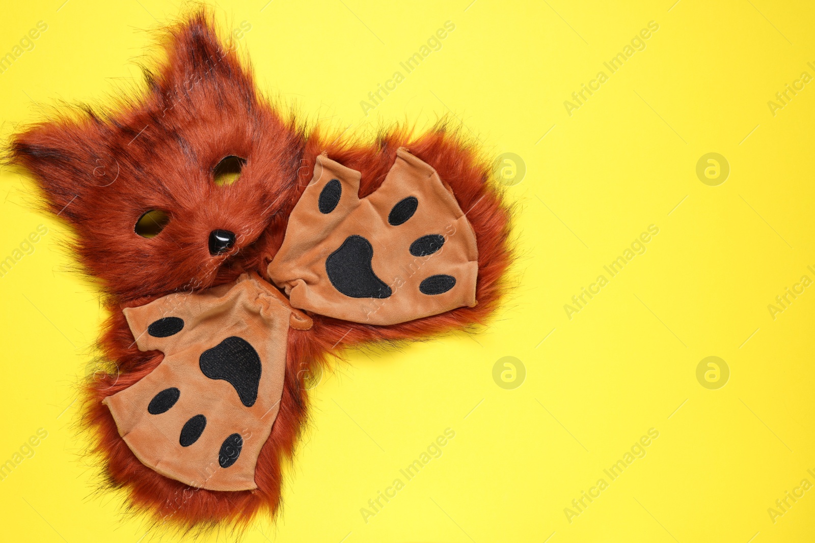 Photo of Quadrobics. Fox mask and gloves on yellow background, top view. Space for text