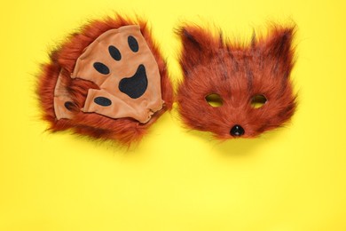 Photo of Quadrobics. Fox mask and gloves on yellow background, top view. Space for text