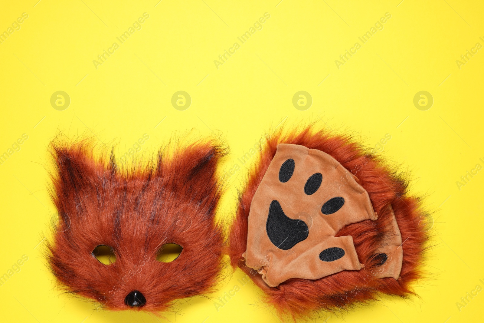 Photo of Quadrobics. Fox mask and gloves on yellow background, top view. Space for text