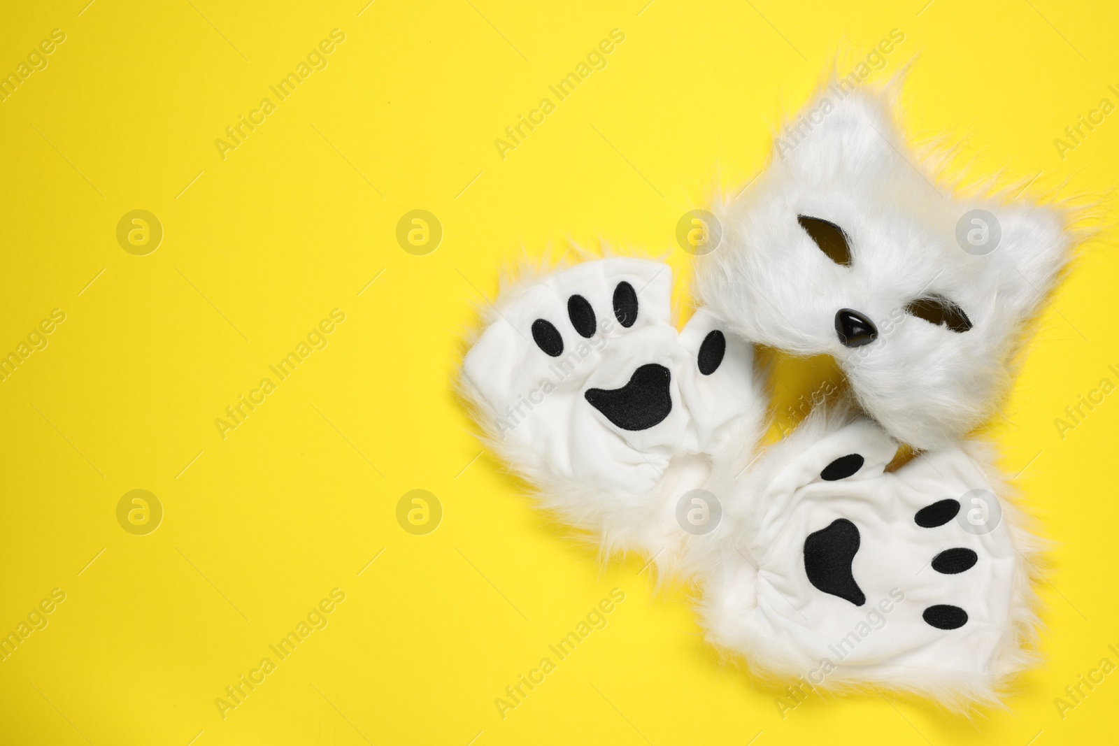 Photo of Quadrobics. Cat mask and gloves on yellow background, top view. Space for text