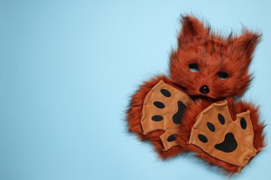 Photo of Quadrobics. Fox mask and gloves on light blue background, top view. Space for text