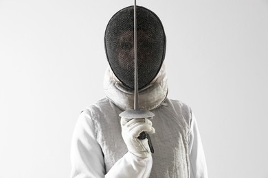 Photo of Fencer with epee on white background. Combat sport