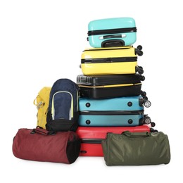 Photo of Stack of colorful suitcases, backpacks and bags isolated on white