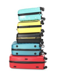 Photo of Stack of colorful suitcases isolated on white