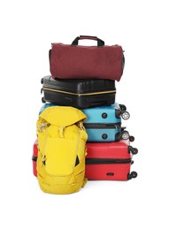 Photo of Stack of colorful suitcases, backpack and bag isolated on white