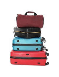 Photo of Stack of colorful suitcases and bag isolated on white