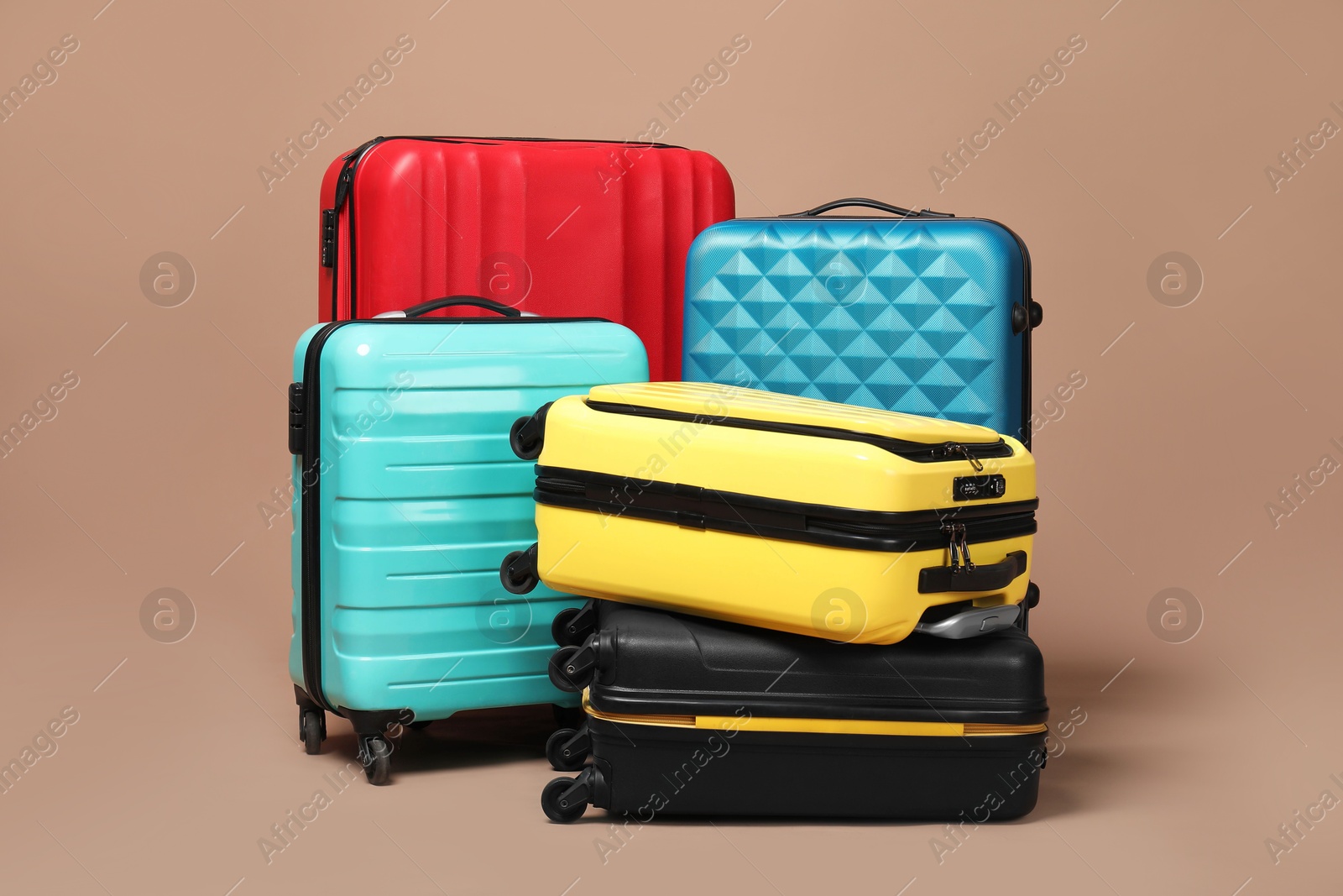 Photo of Many closed colorful suitcases on beige background