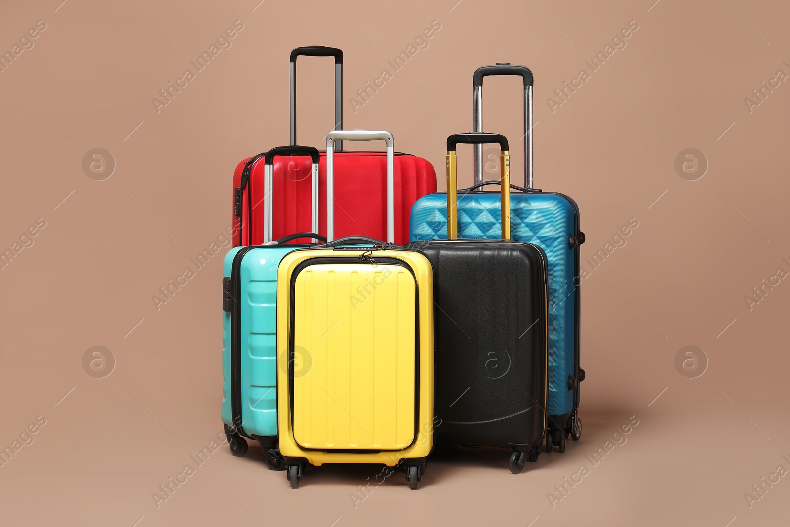 Photo of Many closed colorful suitcases on beige background