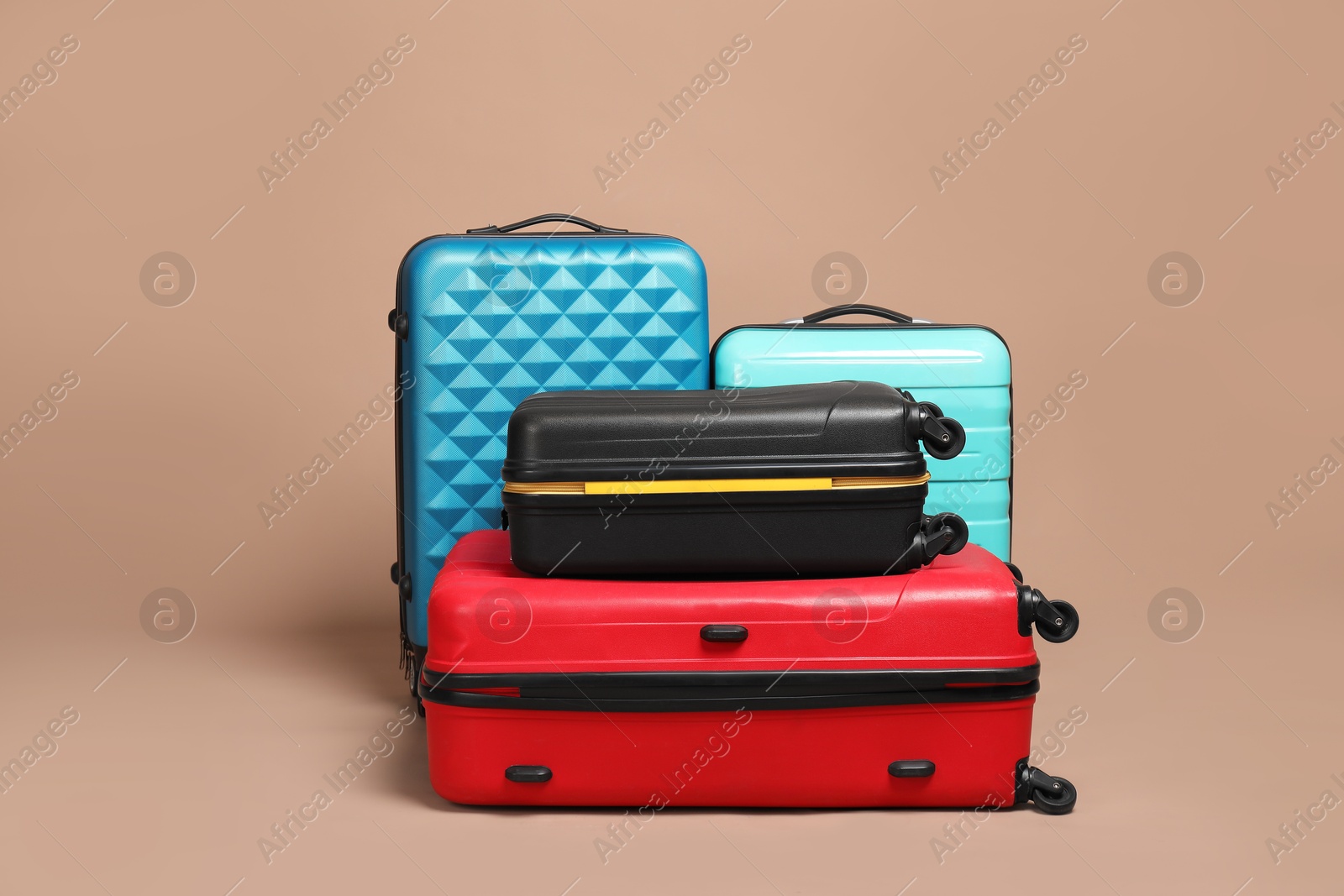 Photo of Many closed colorful suitcases on beige background