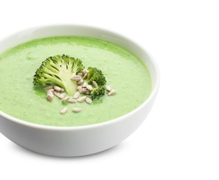 Photo of Delicious broccoli cream soup with sunflower seeds in bowl isolated on white