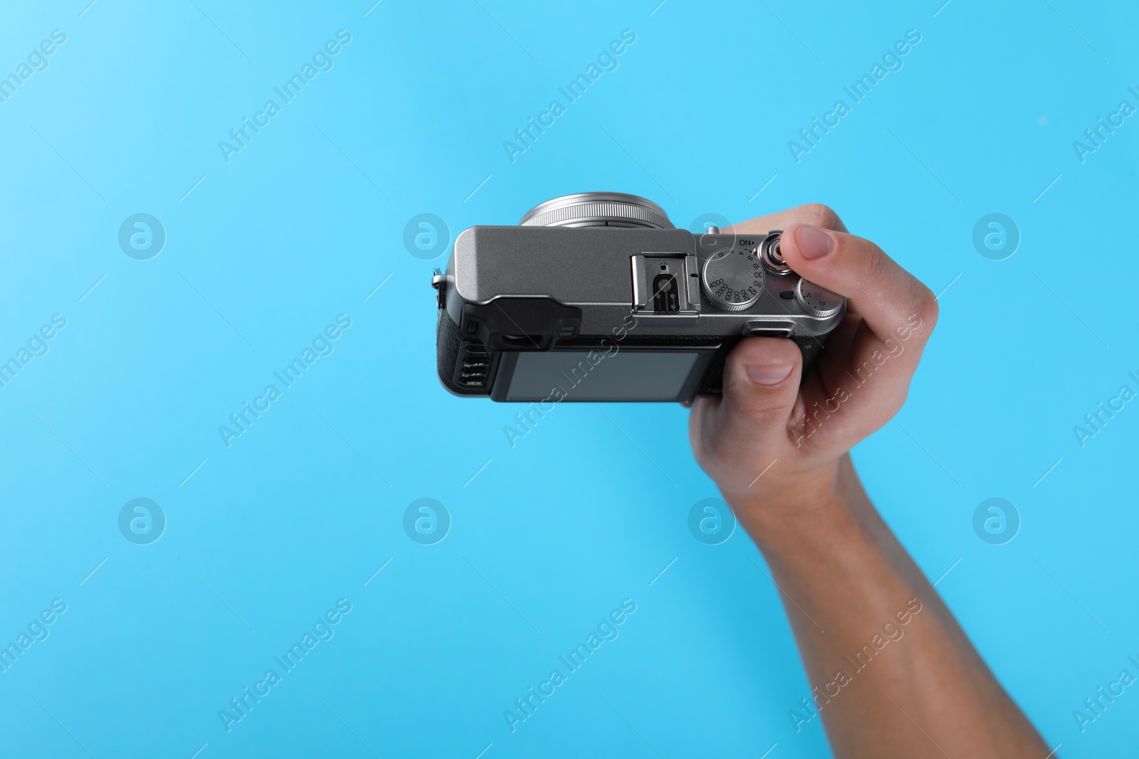 Photo of Photographer with vintage camera on light blue background, above view