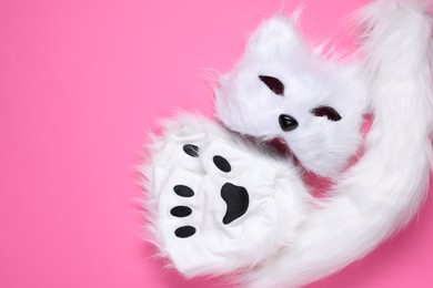 Photo of Quadrobics. Cat mask, tail and gloves on pink background, top view. Space for text