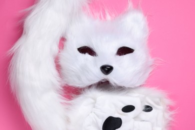 Photo of Quadrobics. Cat mask, tail and gloves on pink background, top view