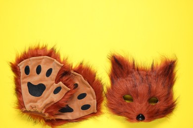 Photo of Quadrobics. Fox mask and gloves on yellow background, top view. Space for text