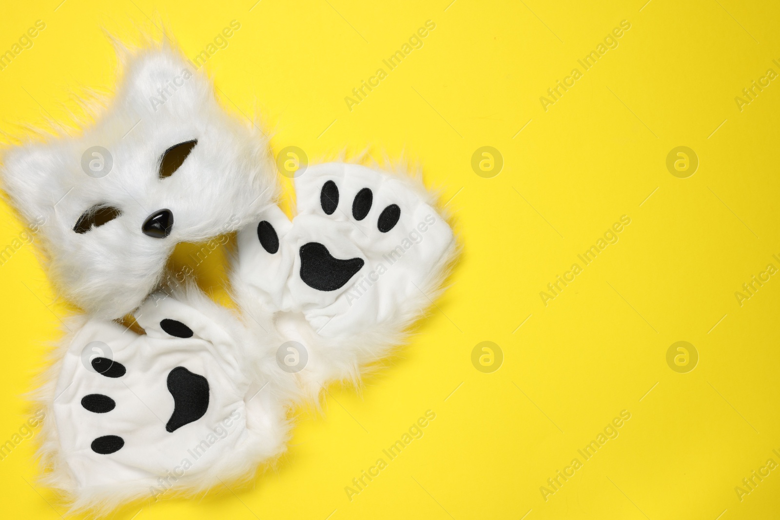 Photo of Quadrobics. Cat mask and gloves on yellow background, top view. Space for text