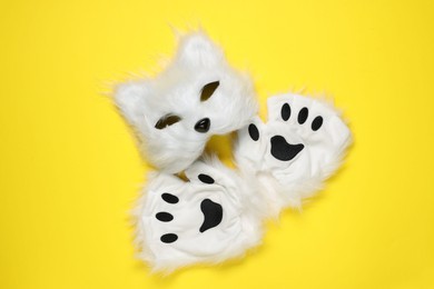 Photo of Quadrobics. Cat mask and gloves on yellow background, top view