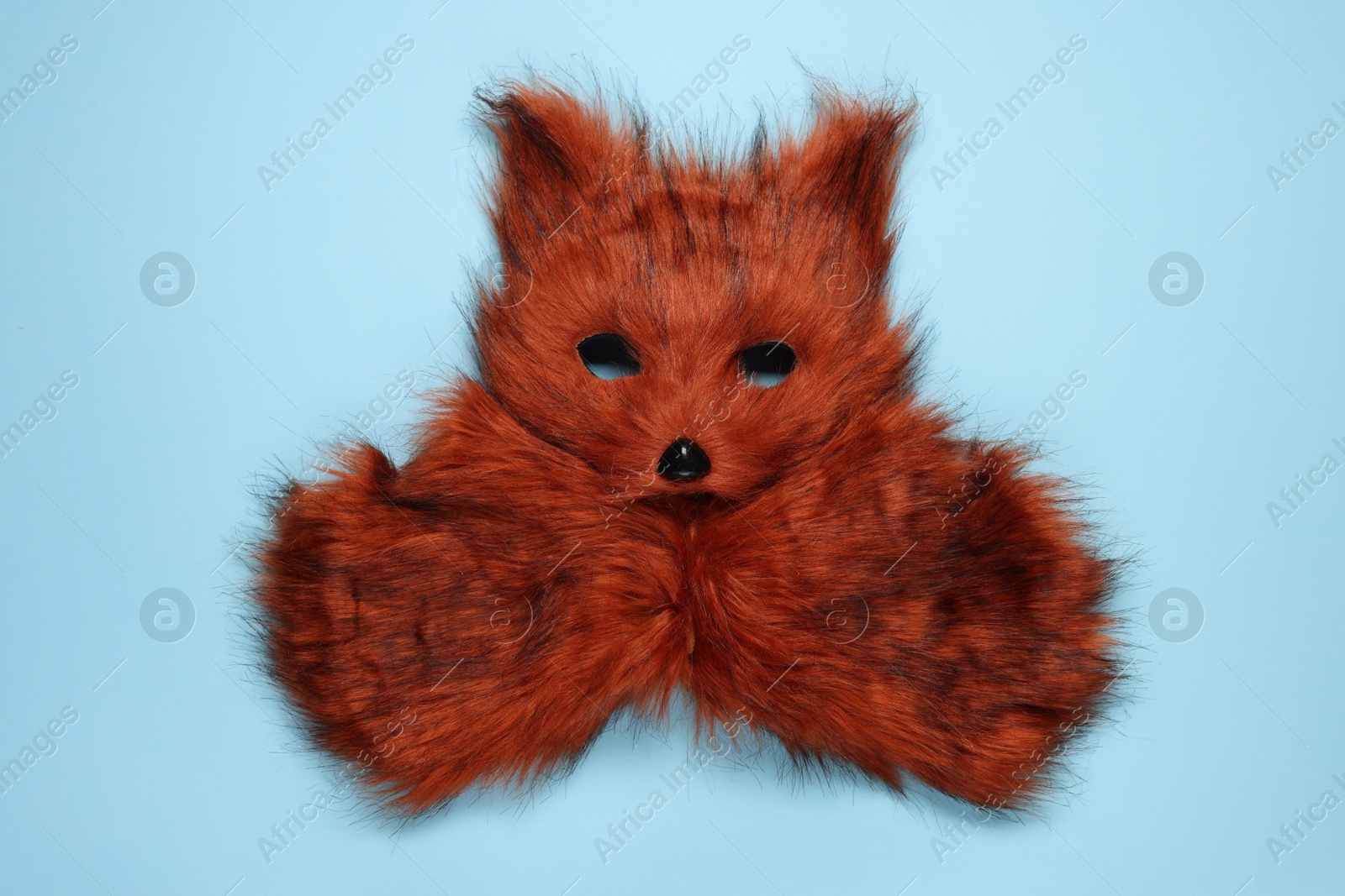 Photo of Quadrobics. Fox mask and gloves on light blue background, top view