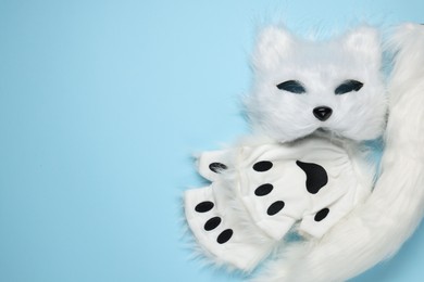 Photo of Quadrobics. Cat mask, tail and gloves on light blue background, top view. Space for text