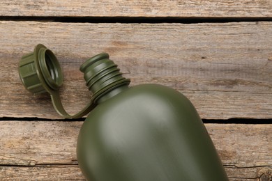 Photo of Green plastic canteen on wooden table, top view