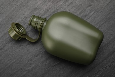 Photo of Green plastic canteen on black table, top view