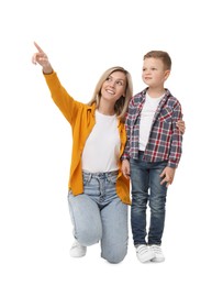 Happy mother with her cute little son looking at something on white background