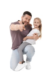 Happy father and his cute little daughter looking at camera on white background