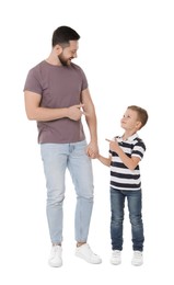 Happy father and his cute little son on white background