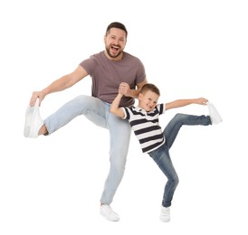 Happy father and his cute little son having fun on white background