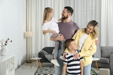 Happy parents and their children at home