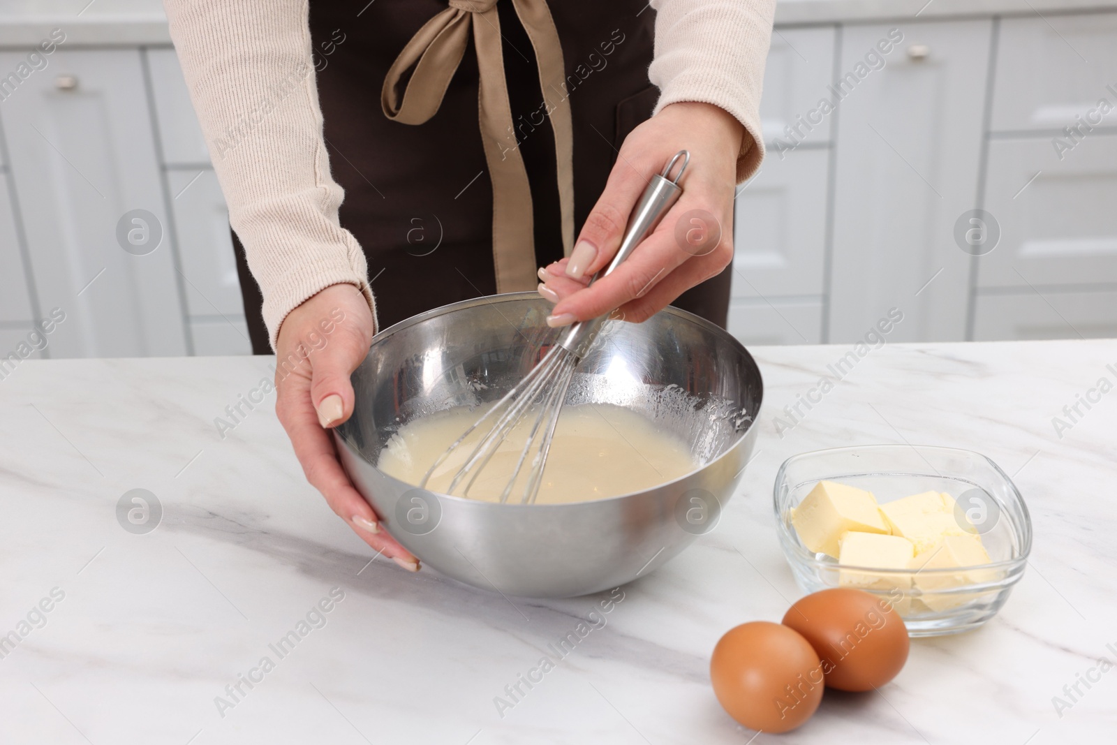 Photo of Woman making dough at white marble table indoors, closeup