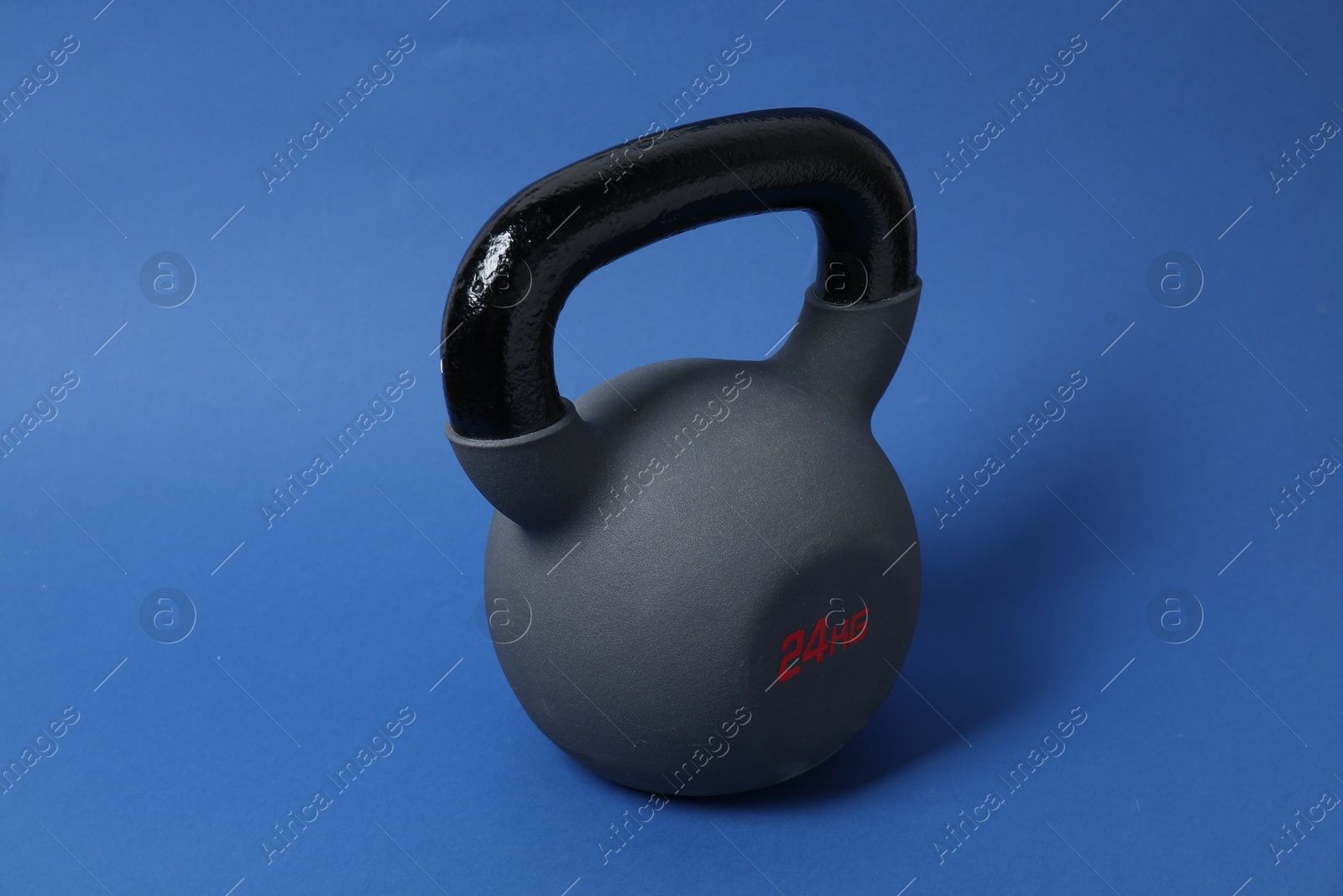 Photo of One kettlebell on blue background. Sport equipment