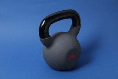 Photo of One kettlebell on blue background. Sport equipment