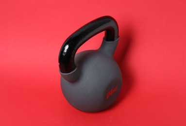 Photo of One kettlebell on red background. Sport equipment