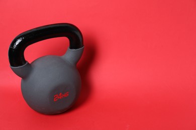 Photo of One kettlebell on red background. Space for text