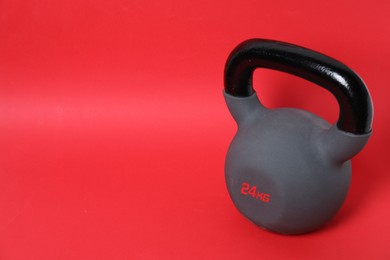 Photo of One kettlebell on red background. Space for text