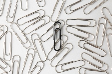 Photo of Many paper clips on light background, flat lay