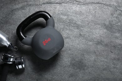 Photo of Kettlebell and dumbbells on grey background, flat lay. Space for text