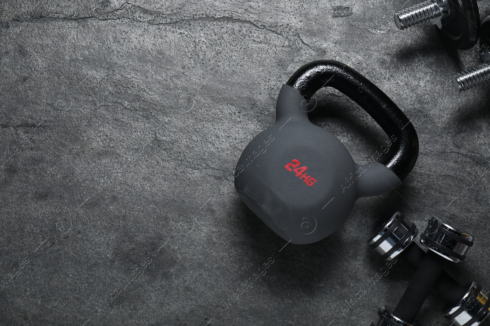 Photo of Kettlebell and dumbbells on grey background, flat lay. Space for text