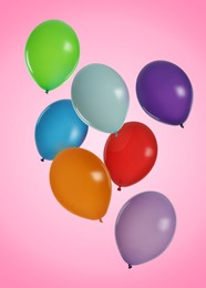 Image of Many colorful balloons in air on pink background. Birthday or other party decoration