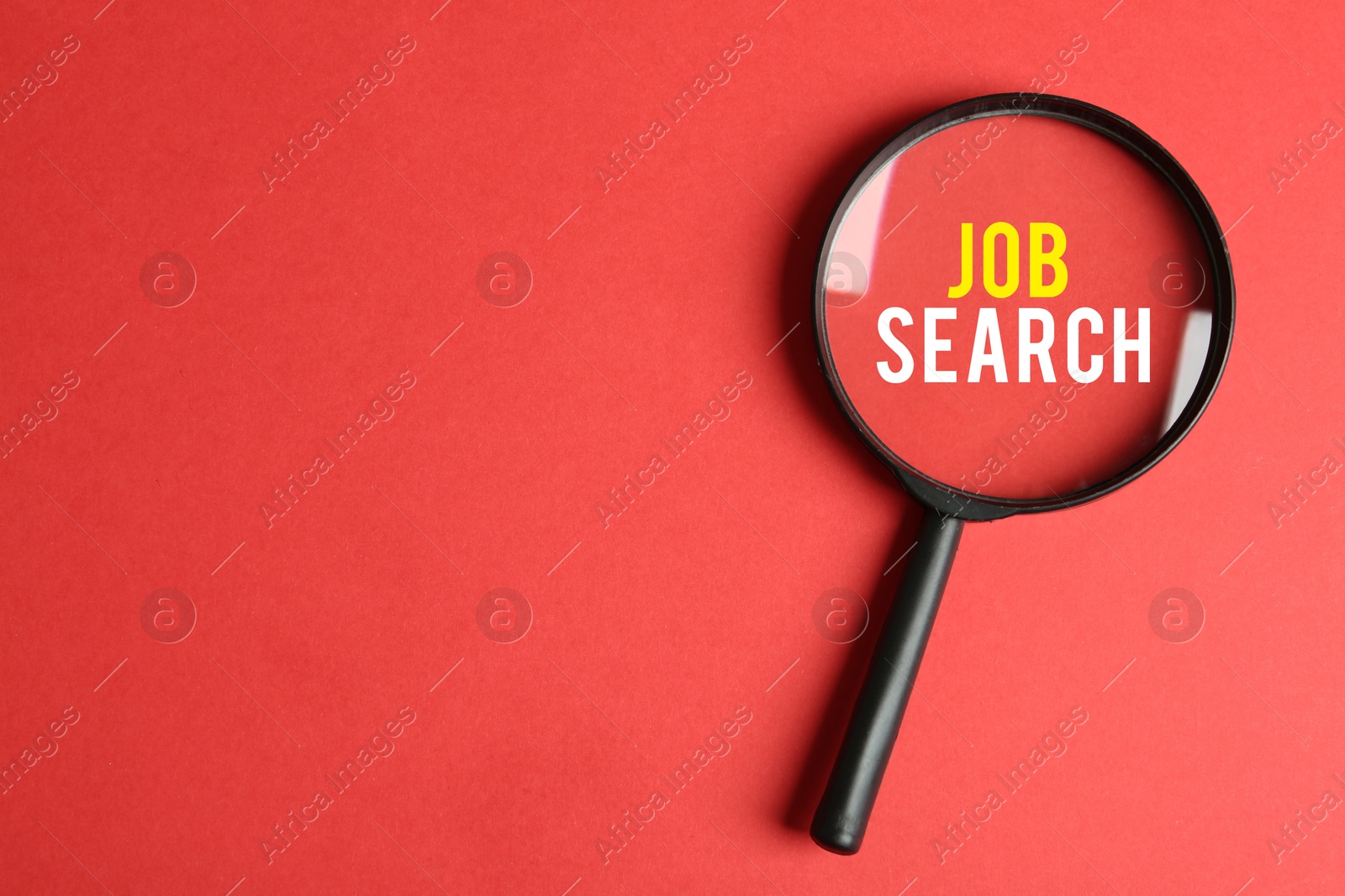 Image of Job Search words on red background, view through magnifying glass