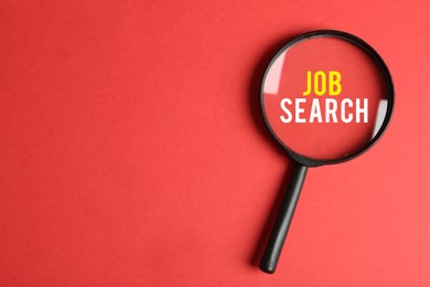 Image of Job Search words on red background, view through magnifying glass