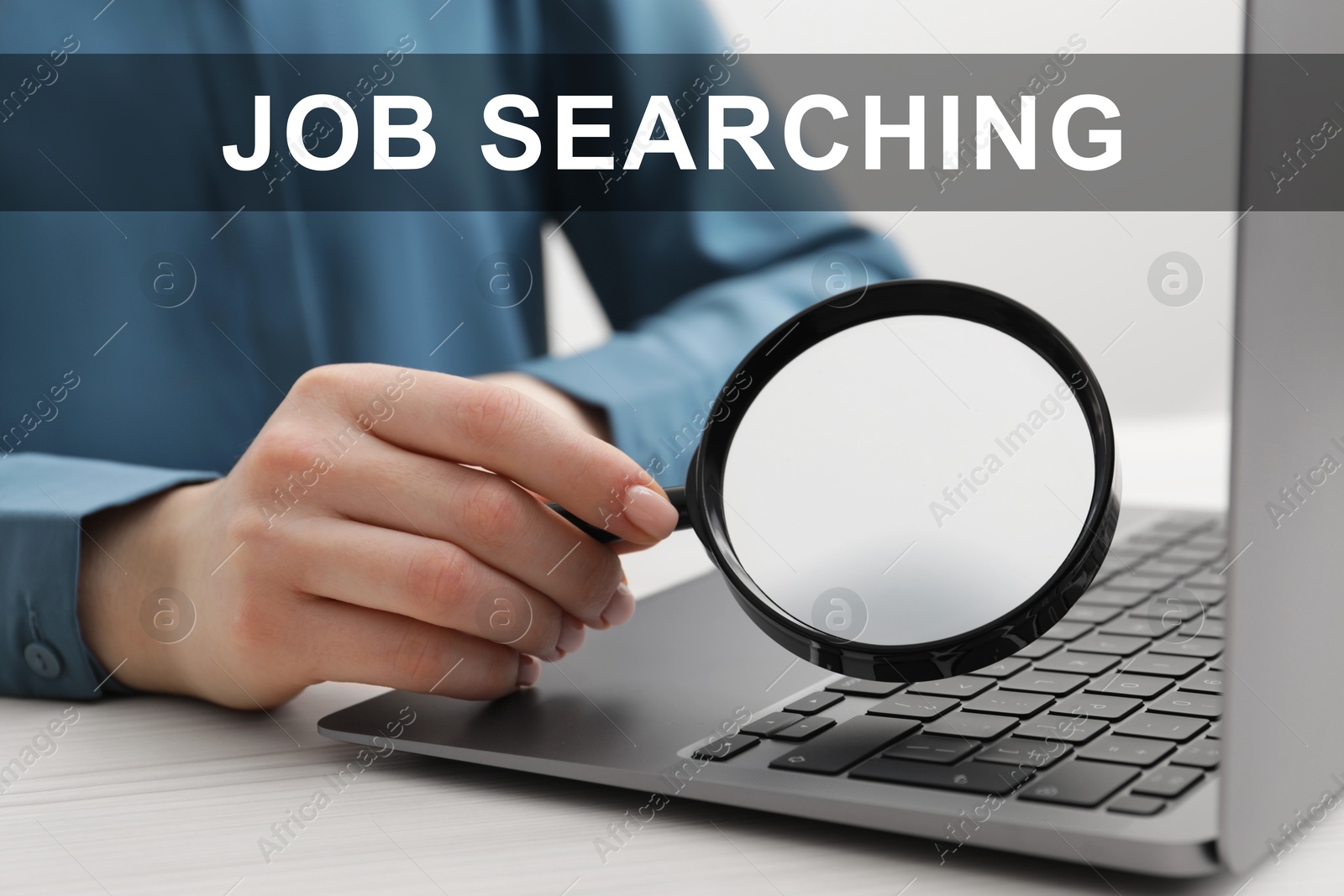 Image of Job search concept. Woman holding magnifying glass near laptop, closeup