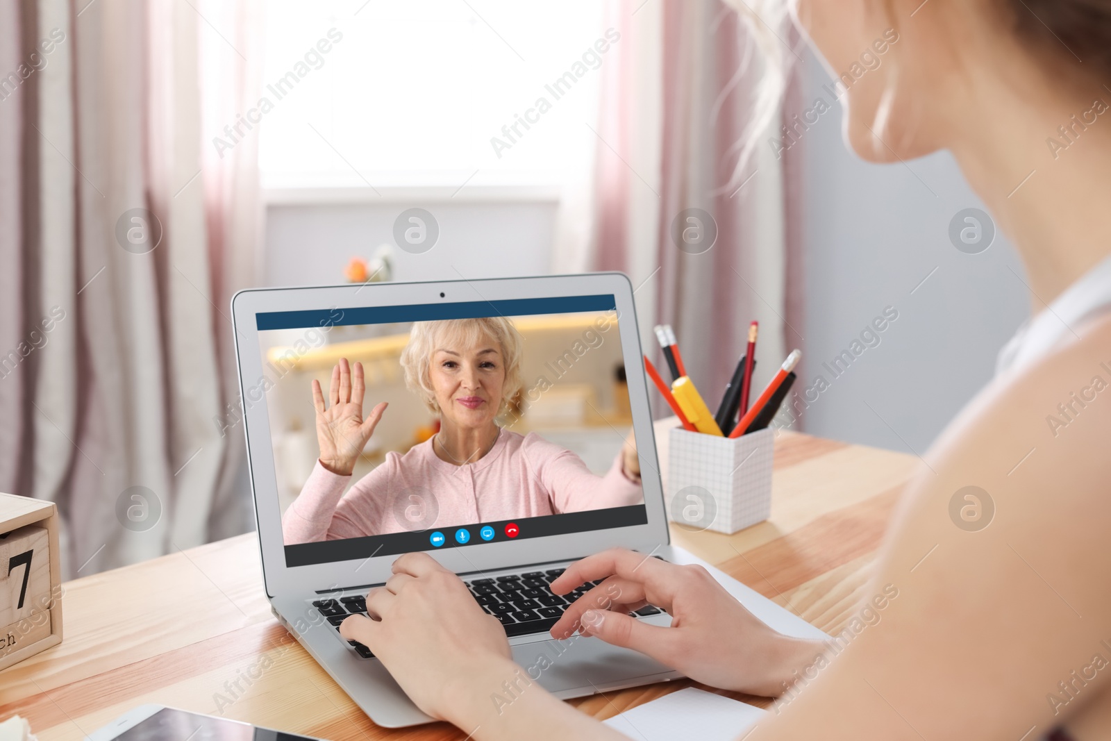 Image of Grandmother and granddaughter talking via video call on laptop. Woman using computer at home, closeup