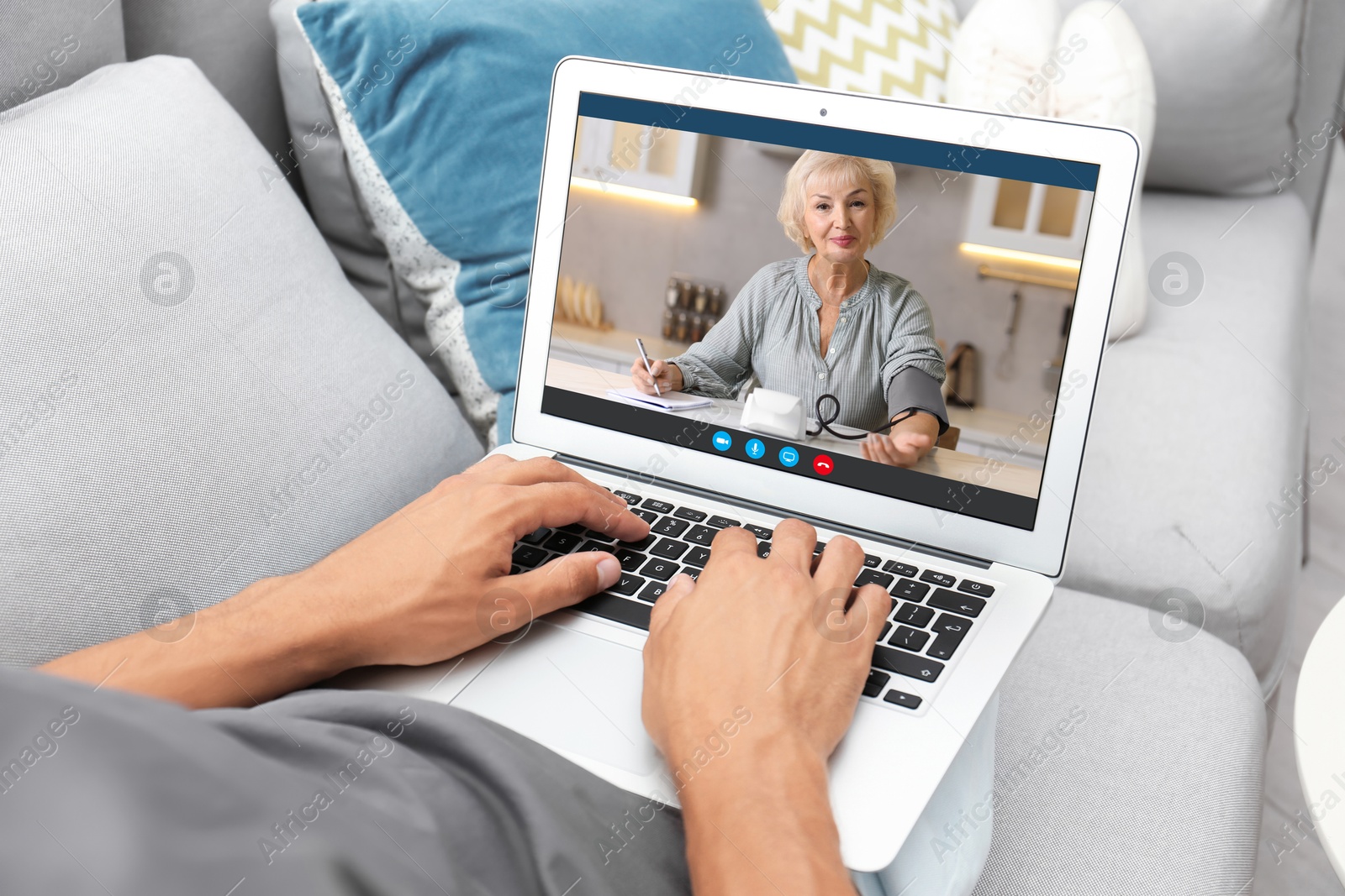 Image of Grandmother and grandson talking via video call on laptop. Man using computer at home, closeup