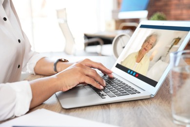 Image of Grandmother and granddaughter talking via video call on laptop. Woman using computer at home, closeup