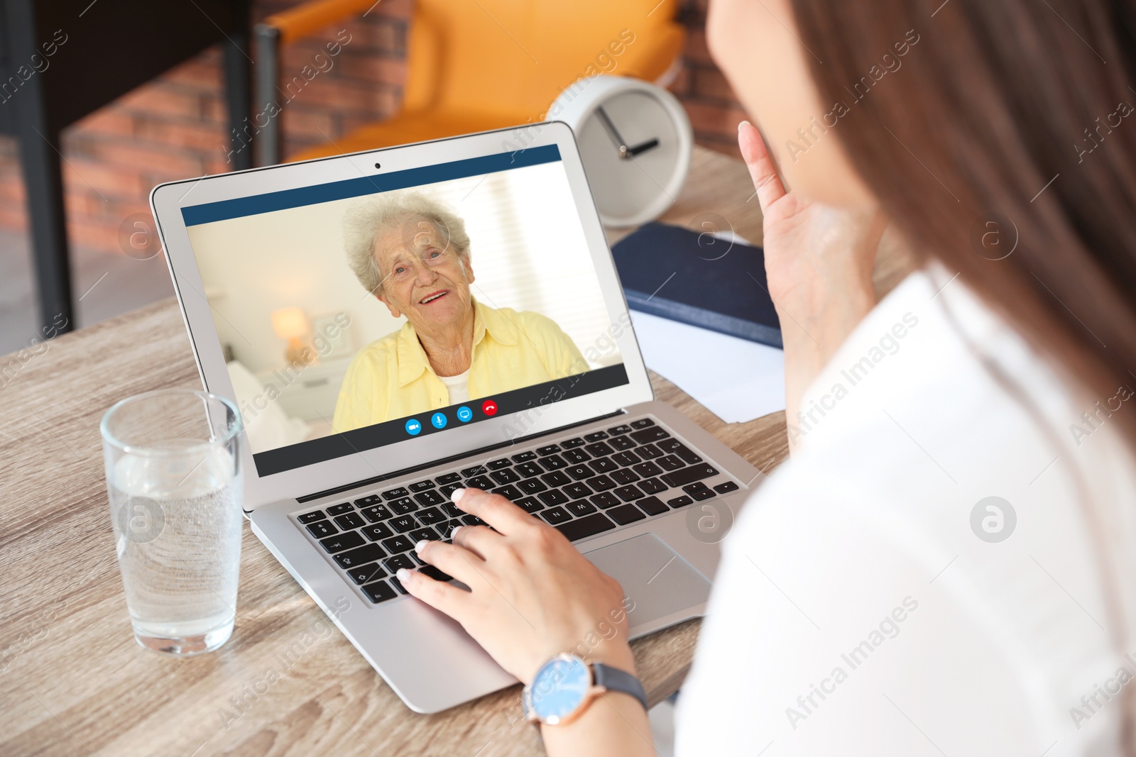 Image of Grandmother and granddaughter talking via video call on laptop. Woman using computer at home, closeup