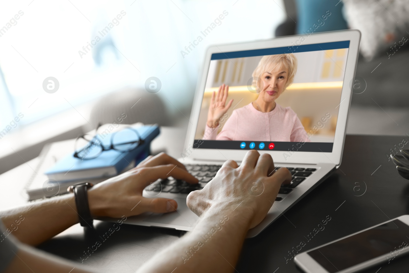 Image of Grandmother and grandson talking via video call on laptop. Man using computer at home, closeup