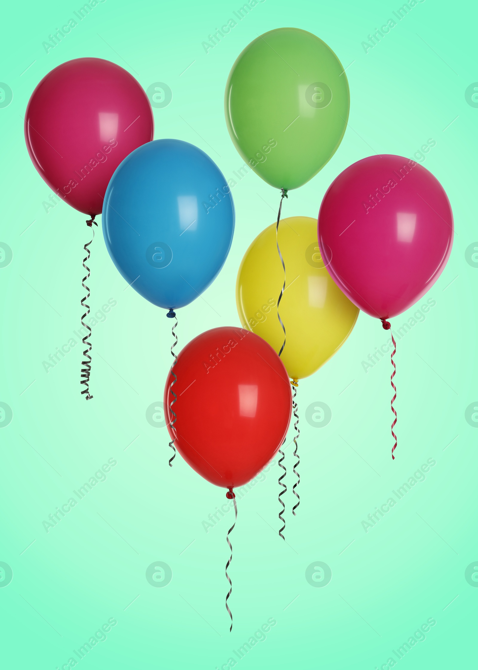 Image of Many colorful balloons in air on turquoise background. Birthday or other party decoration