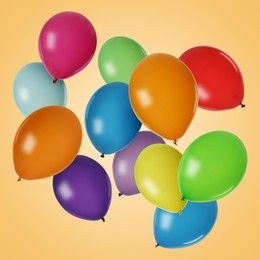 Many colorful balloons in air on orange background. Birthday or other party decoration